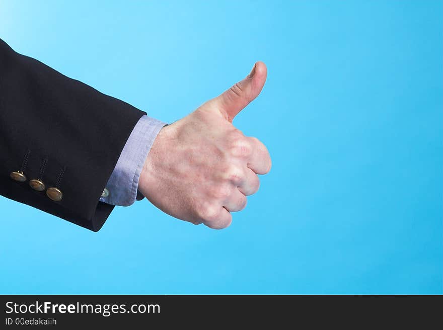 Businessman doing hand sign over blue background