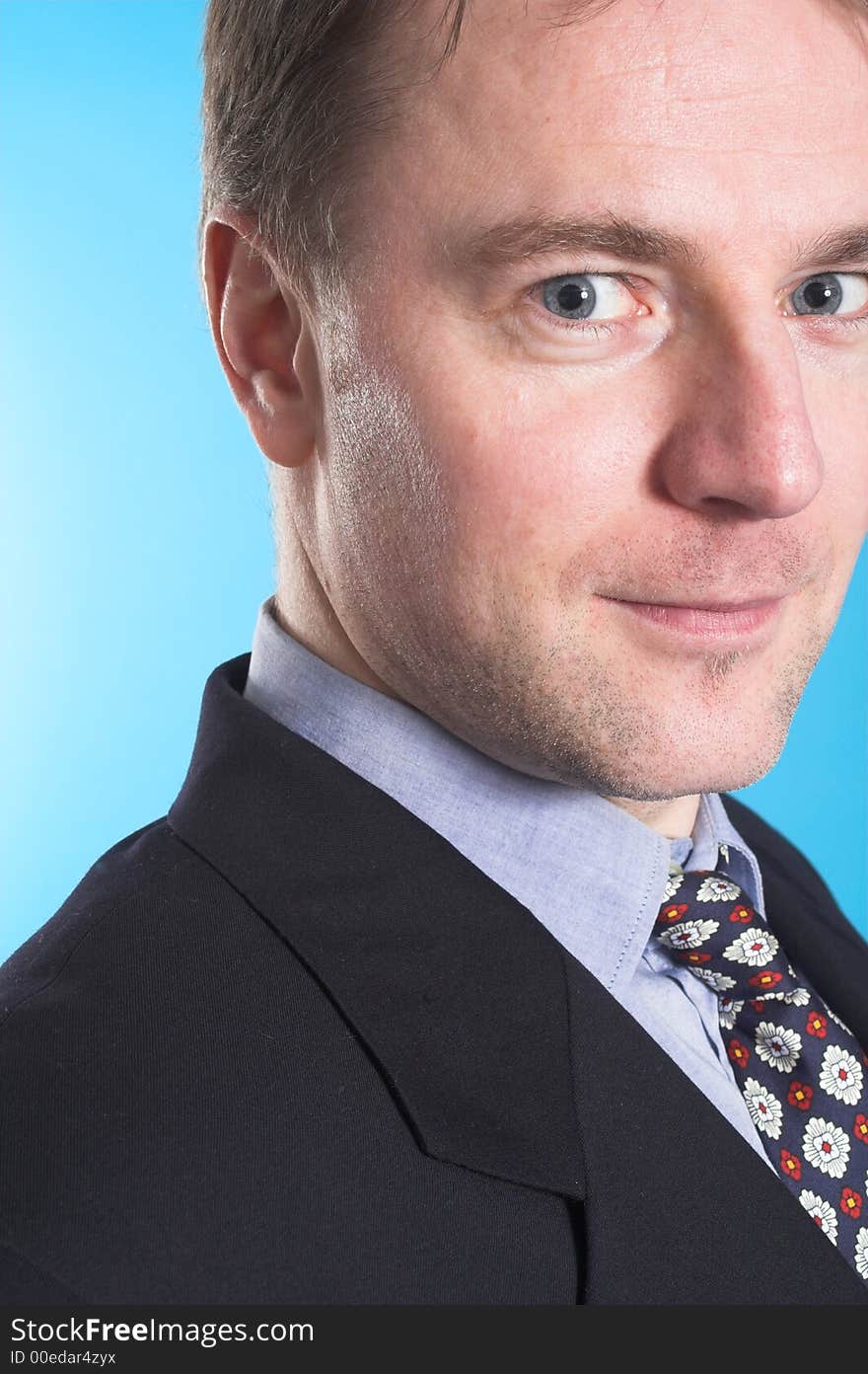 Man in business suit standing over blue background. Man in business suit standing over blue background