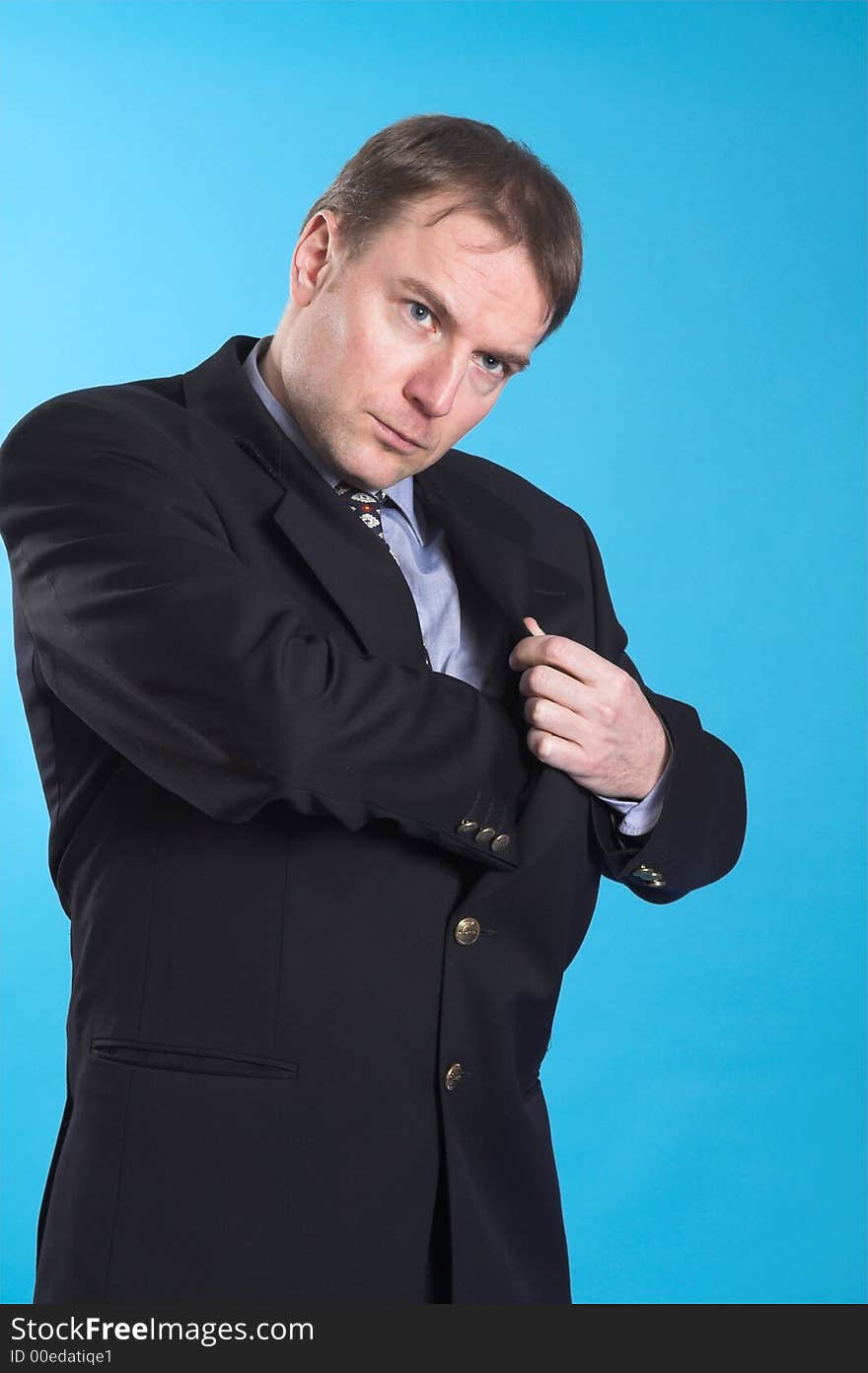 Man in business suit standing over blue background searching his pocket. Man in business suit standing over blue background searching his pocket