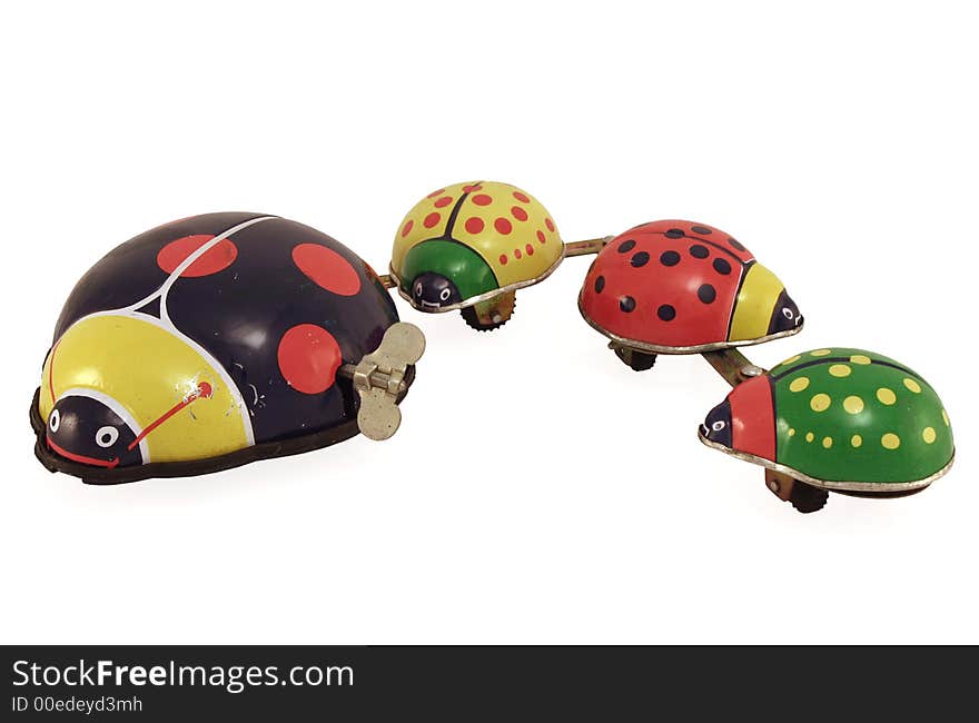 An antique tin toy lady bug with her family attached. An antique tin toy lady bug with her family attached