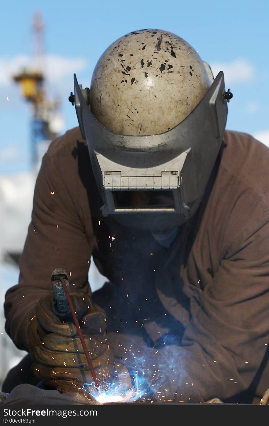 Worker welding steel on dayshift. Worker welding steel on dayshift