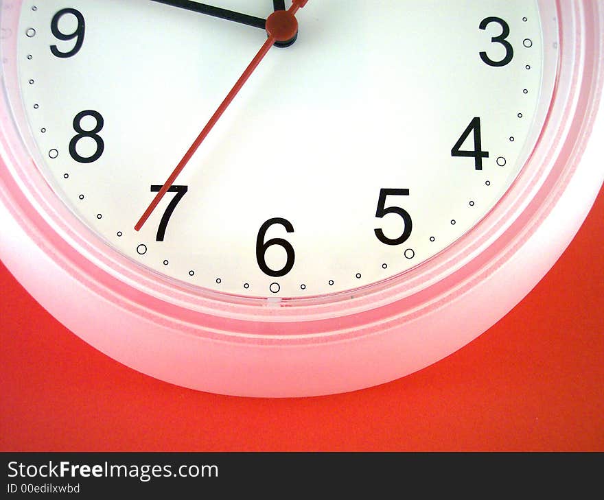 White wall clock on red background