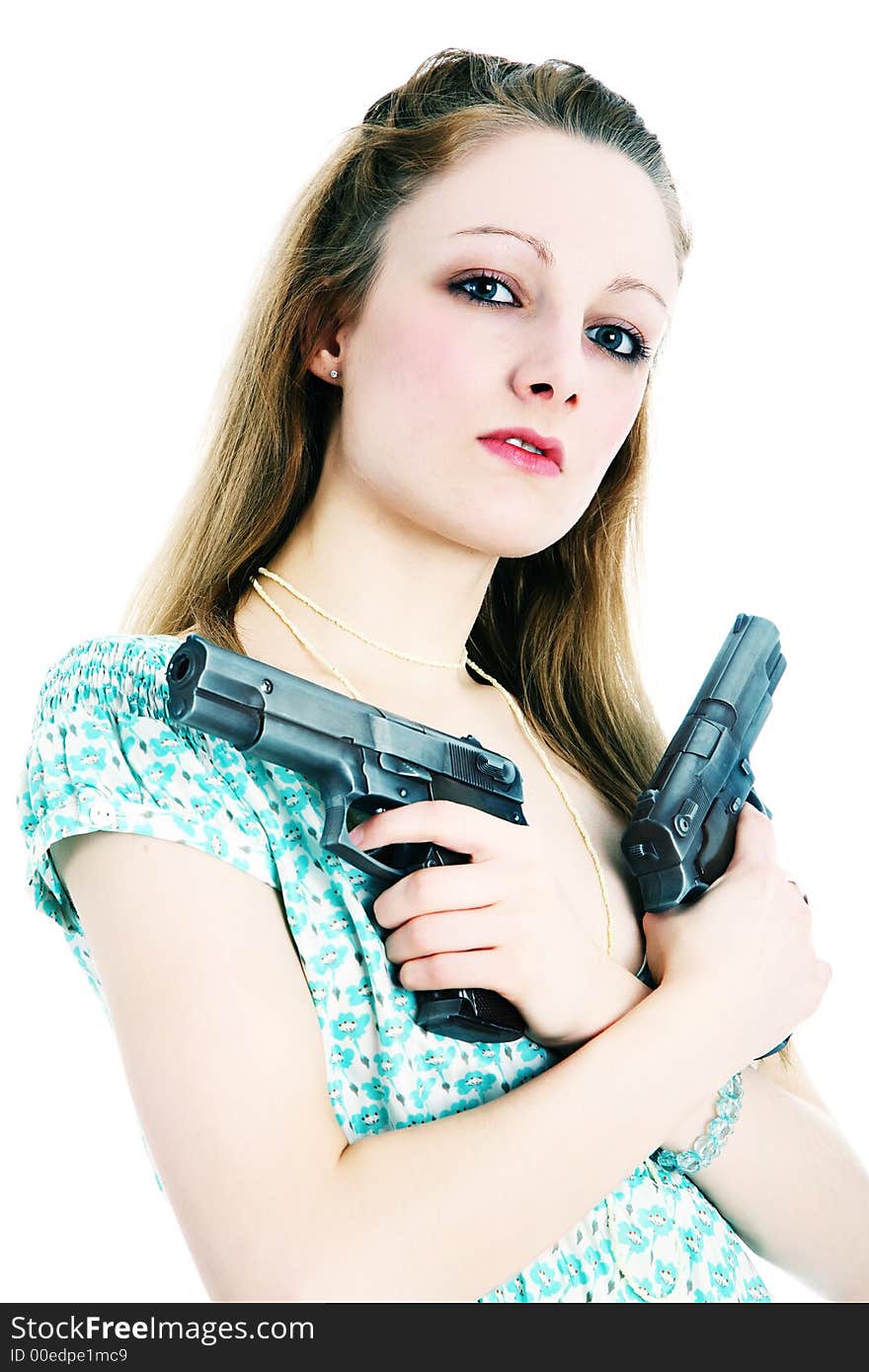 Young woman holding guns across her chest (crossed processed). Young woman holding guns across her chest (crossed processed)