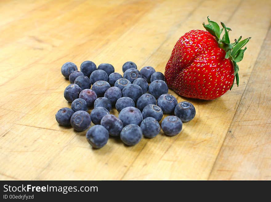 Blueberries and a strawberry