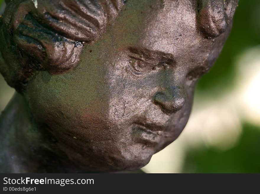 Details of the a bronze statue of a child. Details of the a bronze statue of a child