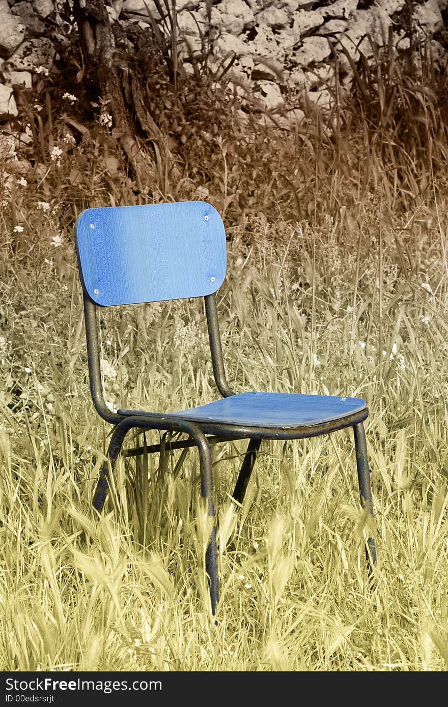 Abandoned chair in the grass in false colors.