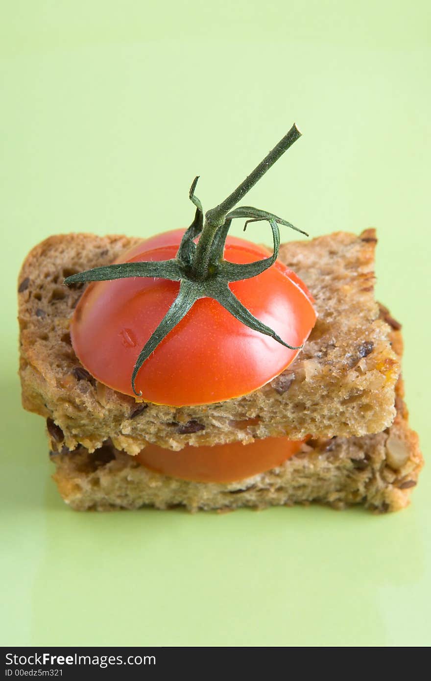 Sliced cherry tomatoe on the piece of rue bread