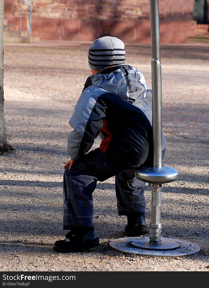 Child makes a break during playing with its friends on playground. Child makes a break during playing with its friends on playground