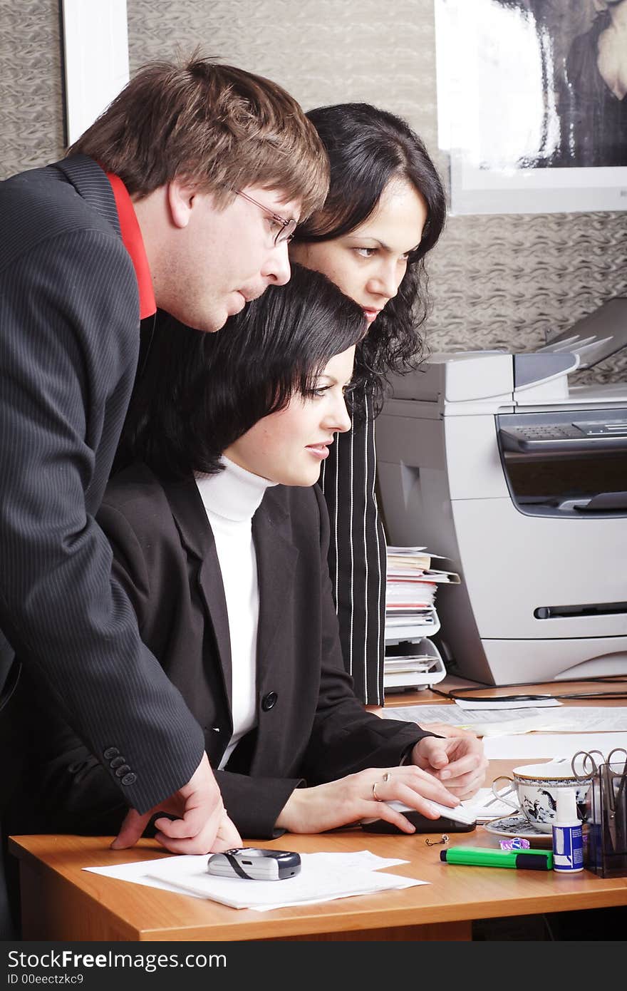 Group of 3 business people working together in the office. Group of 3 business people working together in the office.