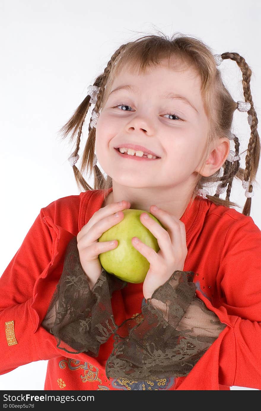 The girl in a red dress with an apple on a white background. The girl in a red dress with an apple on a white background