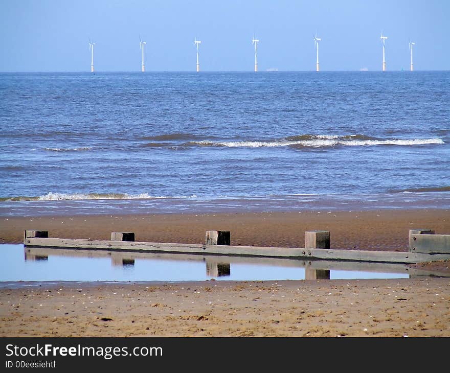 Offshore wind turbines generating electric power. With beach in forground. Offshore wind turbines generating electric power. With beach in forground.