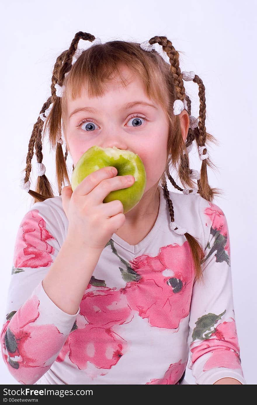 The girl in a dress with an apple on a white background. The girl in a dress with an apple on a white background