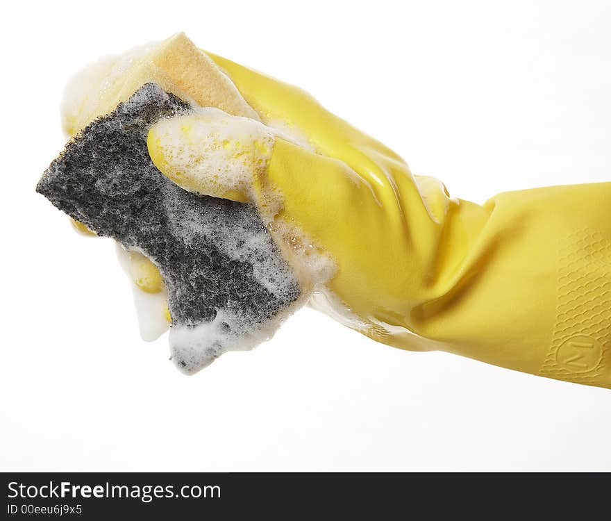 Hand in yellow rubber glove with yellow sponge and foam. Hand in yellow rubber glove with yellow sponge and foam