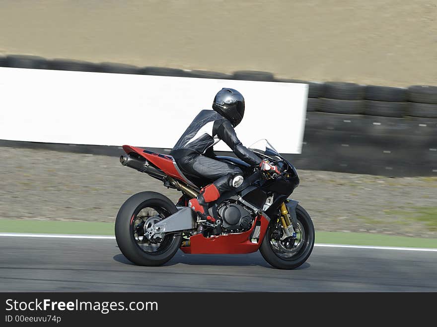 Motor biker an a race track. Motor biker an a race track