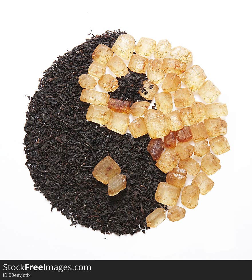 Yin Yang symbol made from different substances ? black tea and sugar. Yin Yang symbol made from different substances ? black tea and sugar
