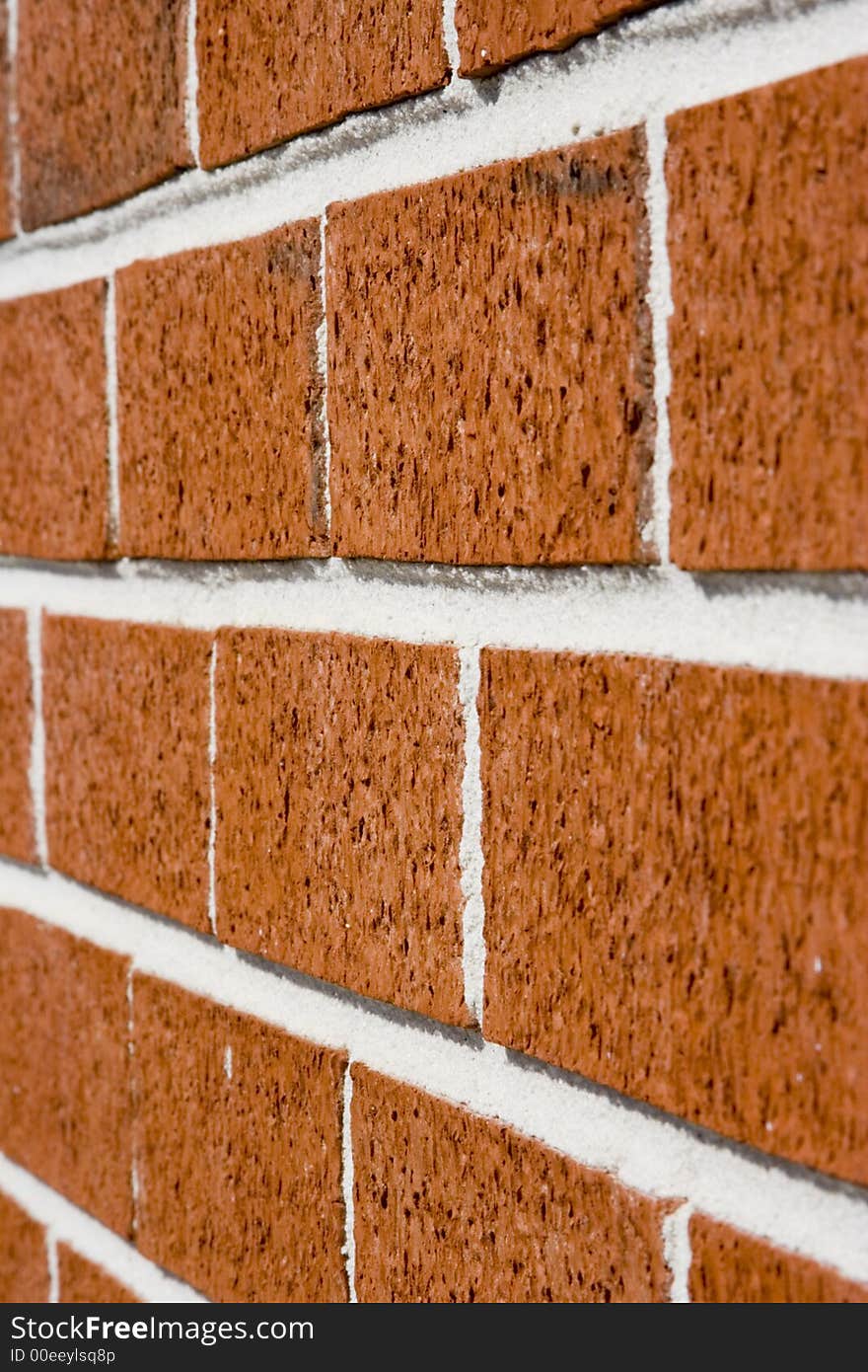 Red brick wall close up shot with selective focus drifting off to blurry. Red brick wall close up shot with selective focus drifting off to blurry.