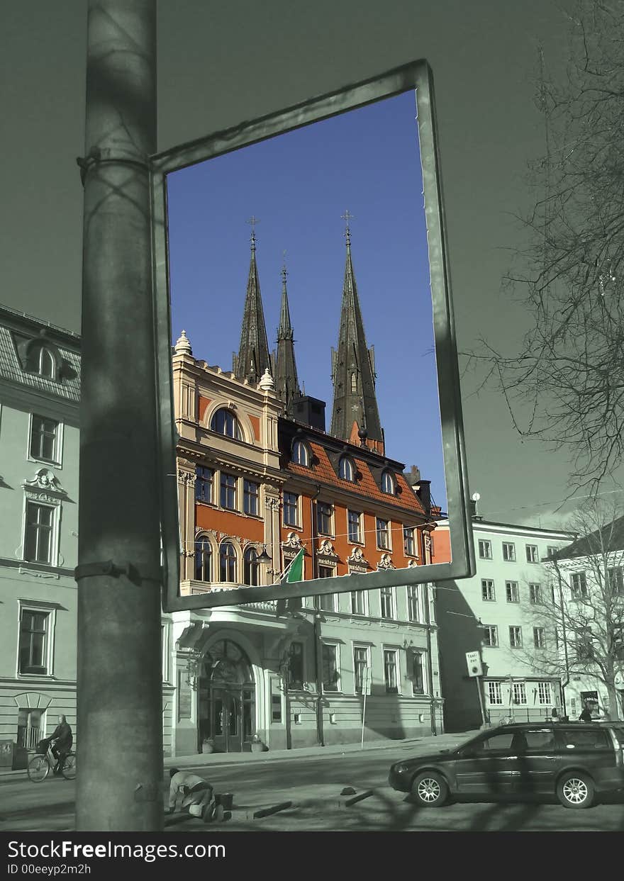 Church towers seen through an empty billboard frame. Church towers seen through an empty billboard frame