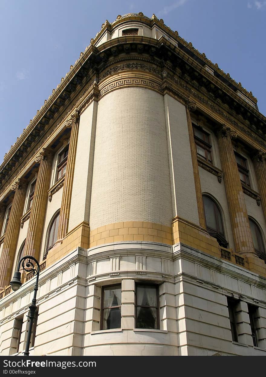 Historic ornate curved building against blue sky. Historic ornate curved building against blue sky