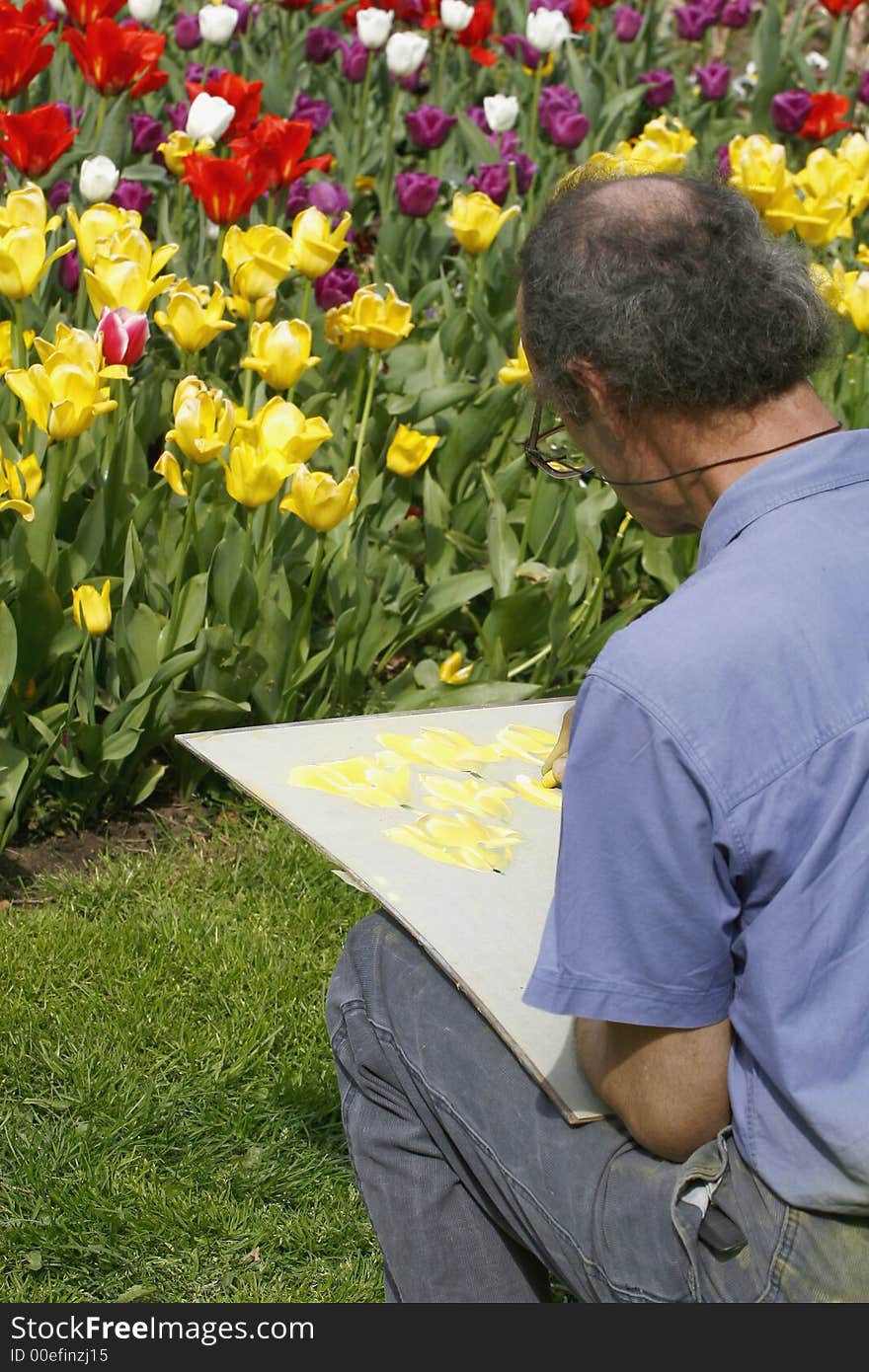 Artist paiter outdoor in tulip field in spring sun. Artist paiter outdoor in tulip field in spring sun