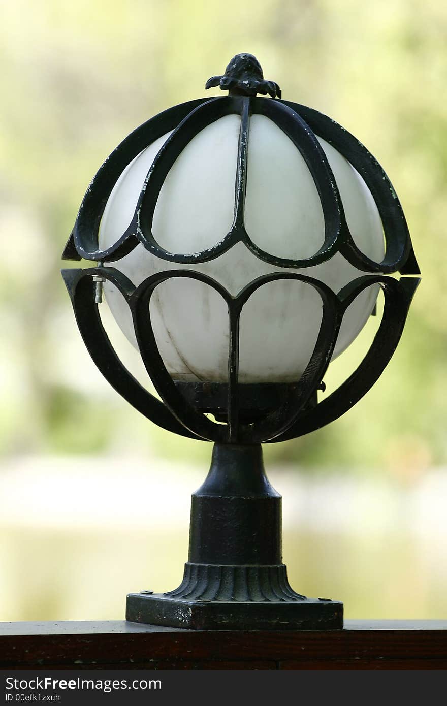 White glass globe trapped by steel. White glass globe trapped by steel