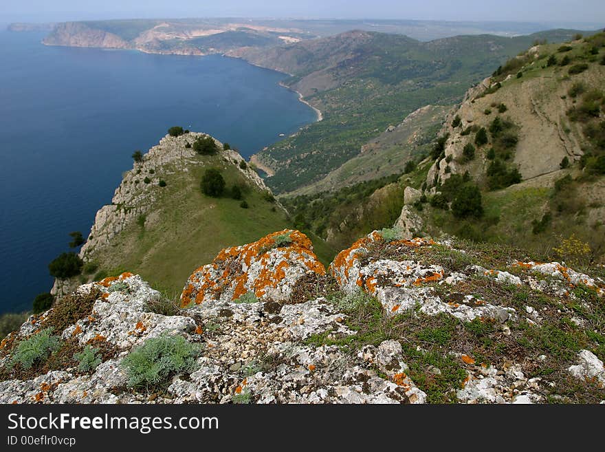 From high top above the sea far capes are visible. From high top above the sea far capes are visible