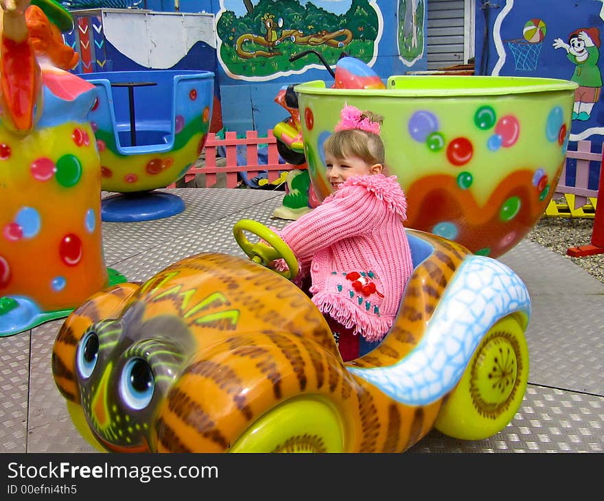 Girl having fun ride on merry go round. Girl having fun ride on merry go round.