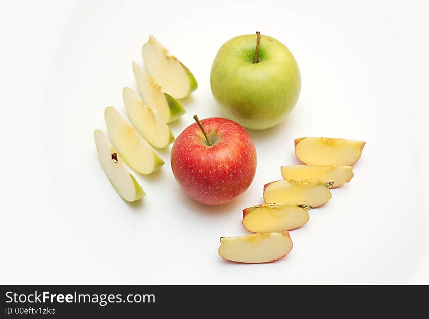 Green and red apple and slices of apples