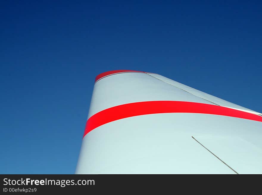 Wing with orange stripes against blue sky