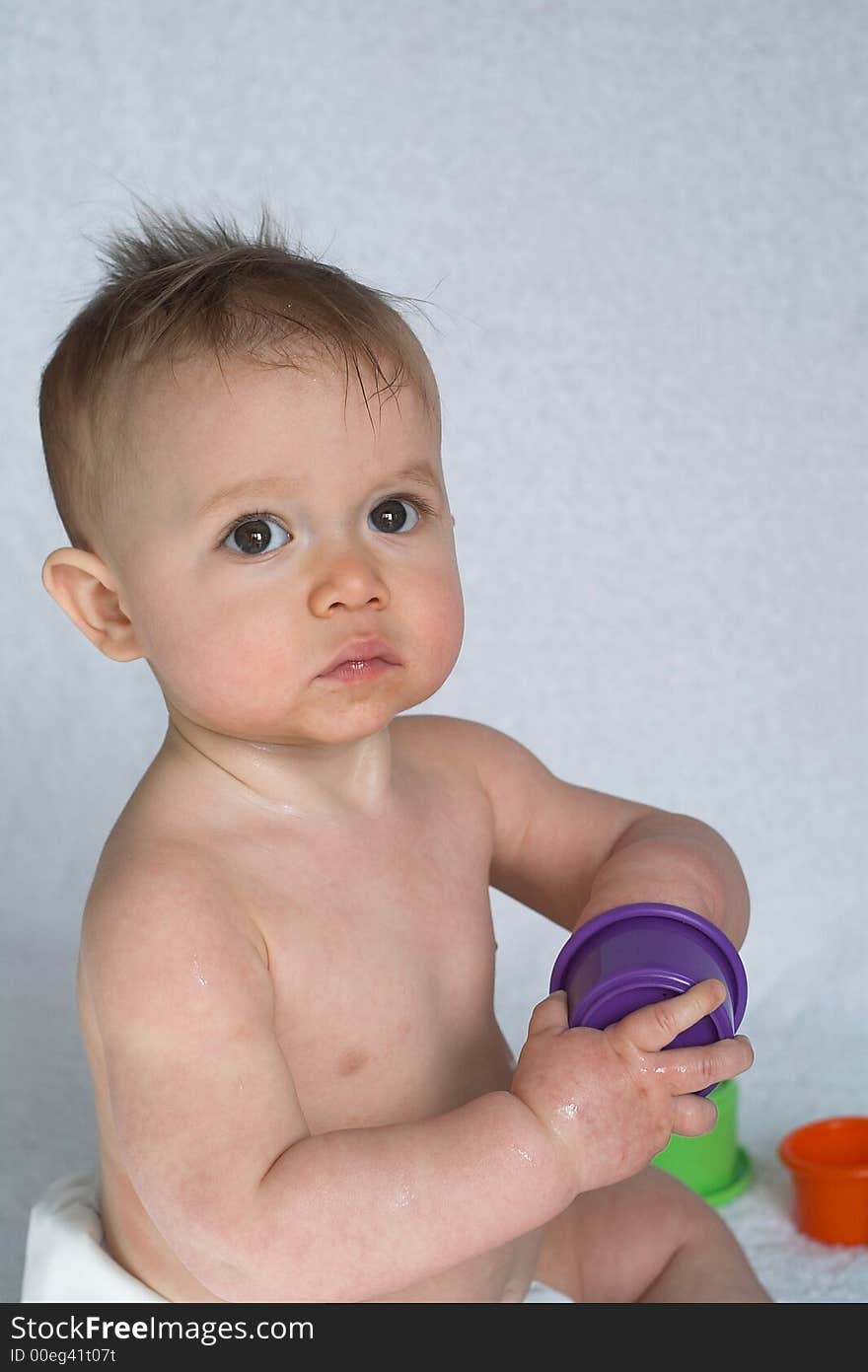 Image of adorable baby playing with stacking cups. Image of adorable baby playing with stacking cups