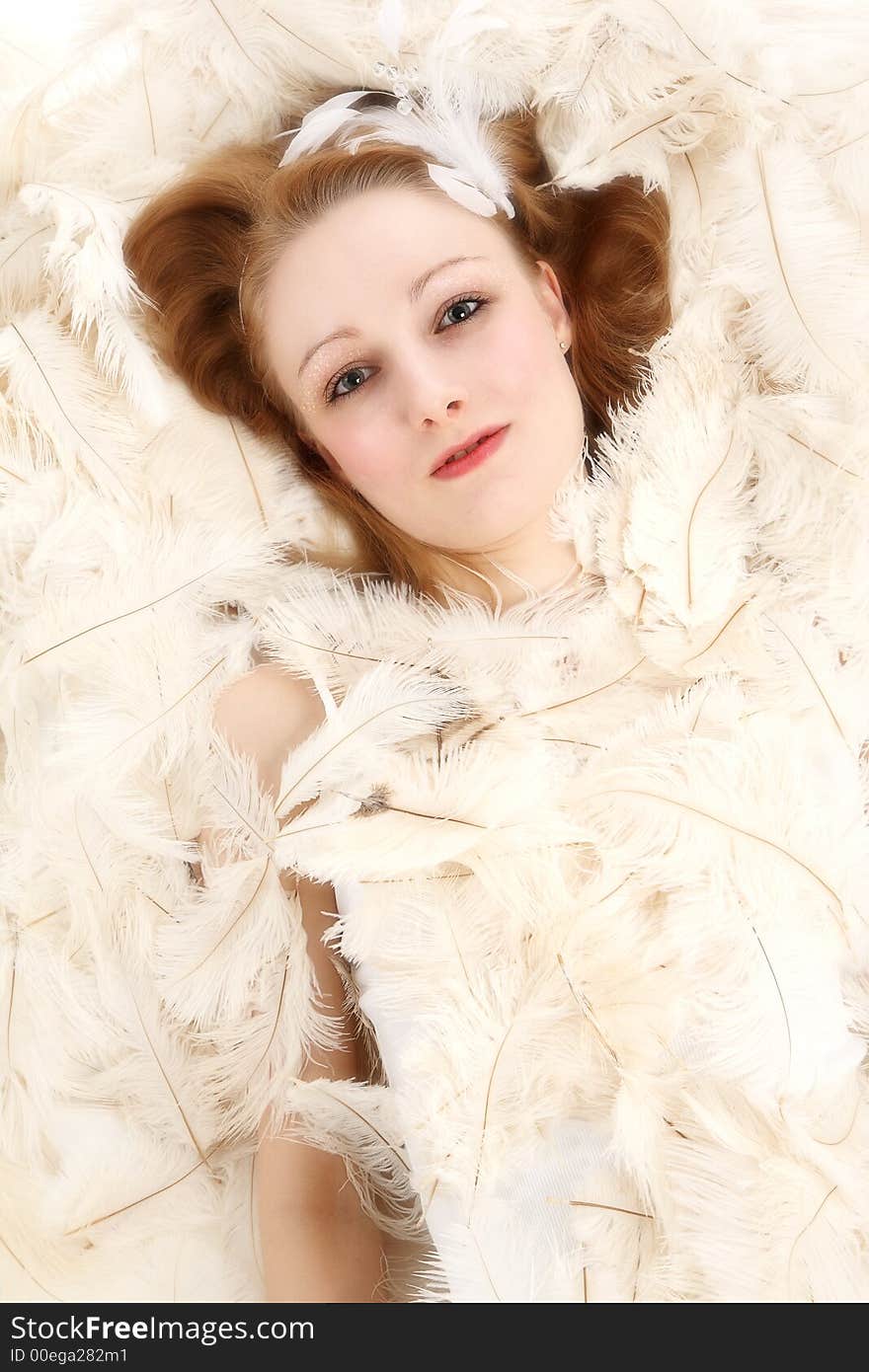 Young woman covered with ostrich feathers. Young woman covered with ostrich feathers