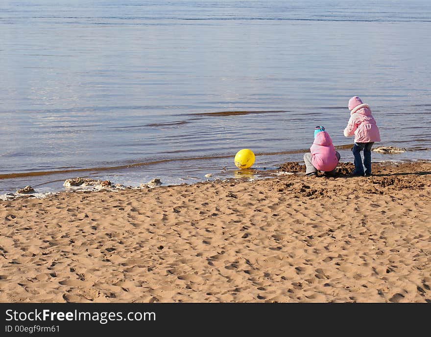 Two little girls play on the beach. Two little girls play on the beach