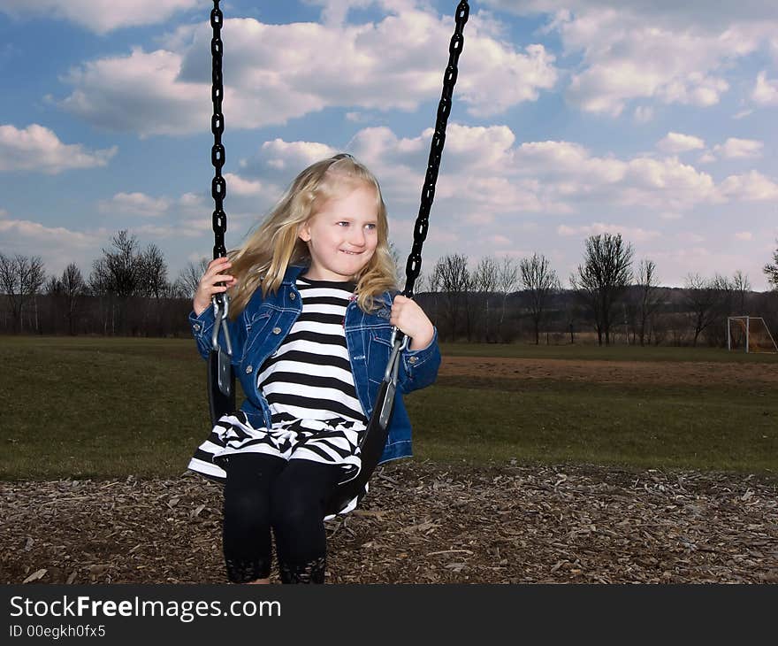 Photo of a girl swinging in a park