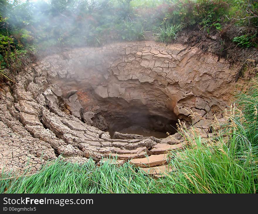 Valley of Geysers, geothermal source, clay cone, steam, hot land, Kamchatka. Valley of Geysers, geothermal source, clay cone, steam, hot land, Kamchatka