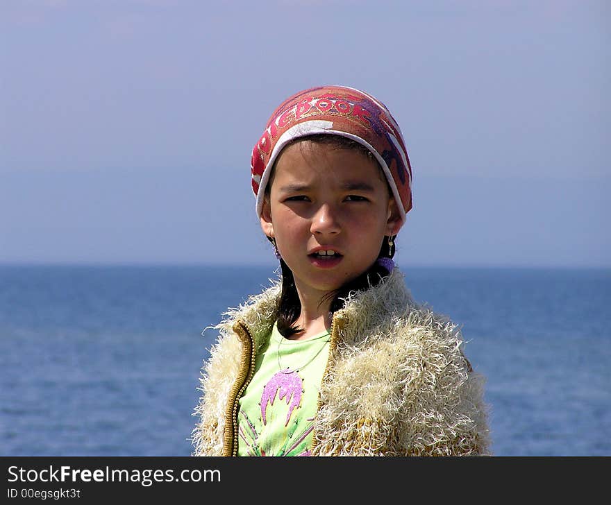 The girl on a background of the sea in the summer