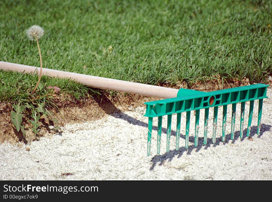 Rake on herb golf field