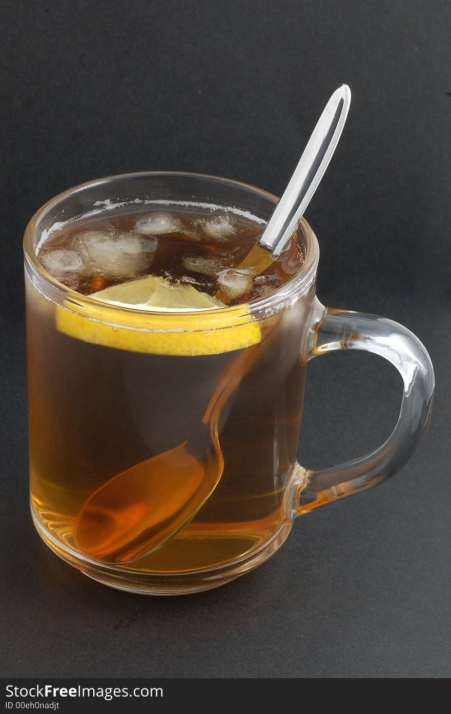 Cup of tea with ice isolated on black