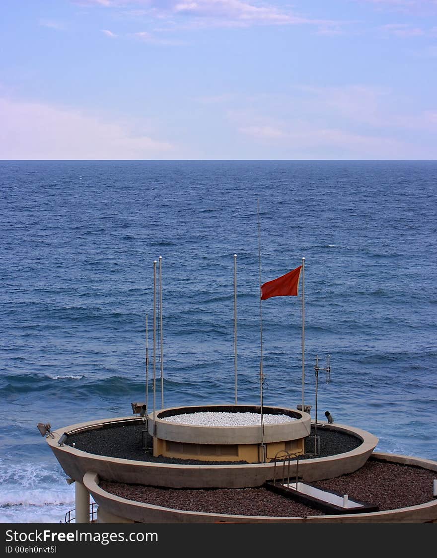 A newly built lifeguard tower with reg flag up to prevent swimming. A newly built lifeguard tower with reg flag up to prevent swimming