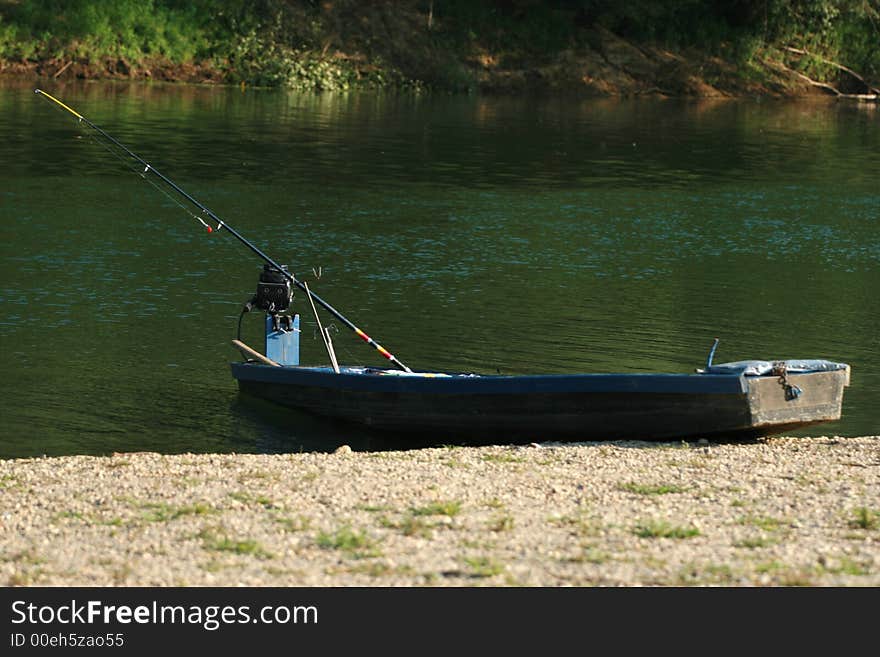 Fishermans boat on green riverside