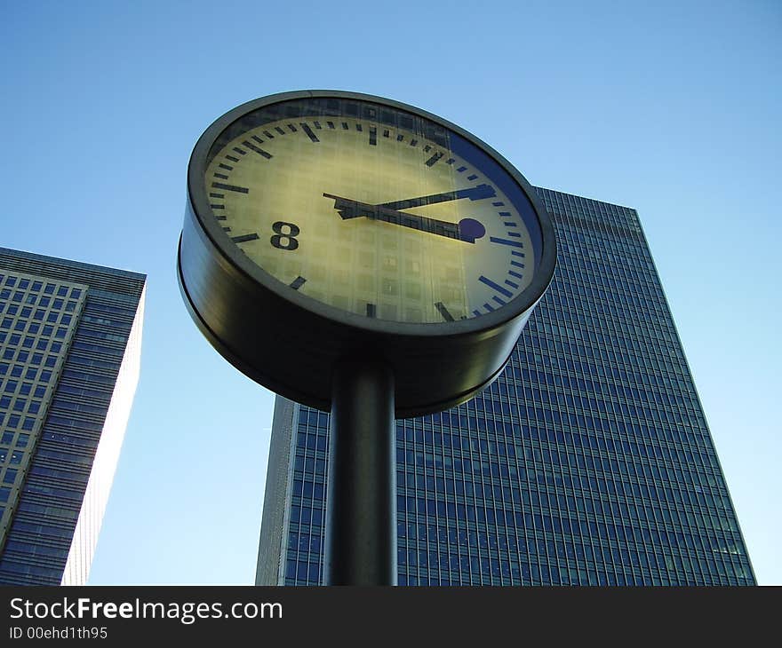 High Skyscraper in Blue Sky with Clock