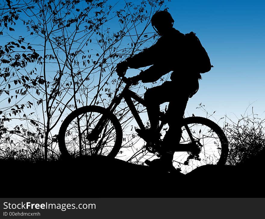 Mountain biker silhouette with clean blue sky