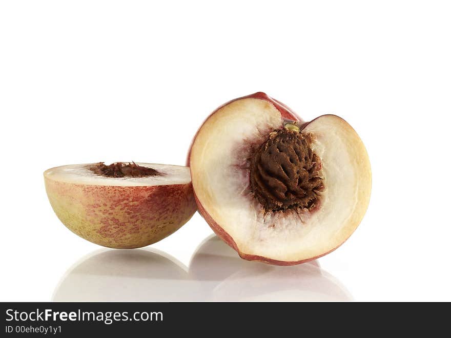 Fresh colored peaches on white background