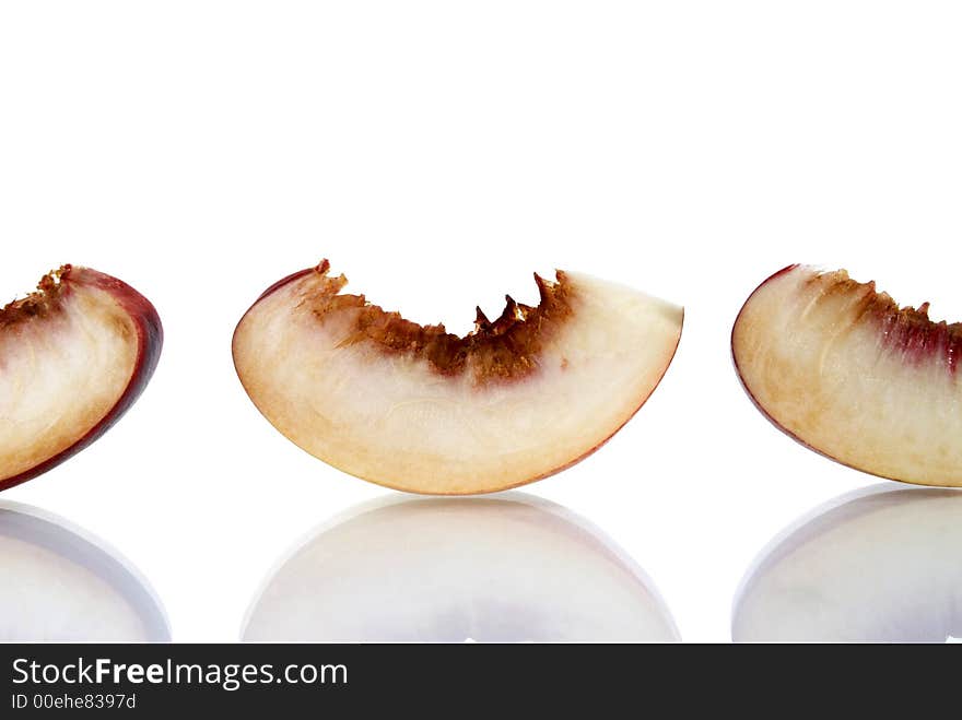 Fresh colored peaches on white background