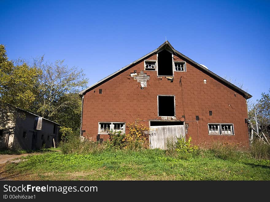 An old abandoned barn in a remote area under sunny blue sky