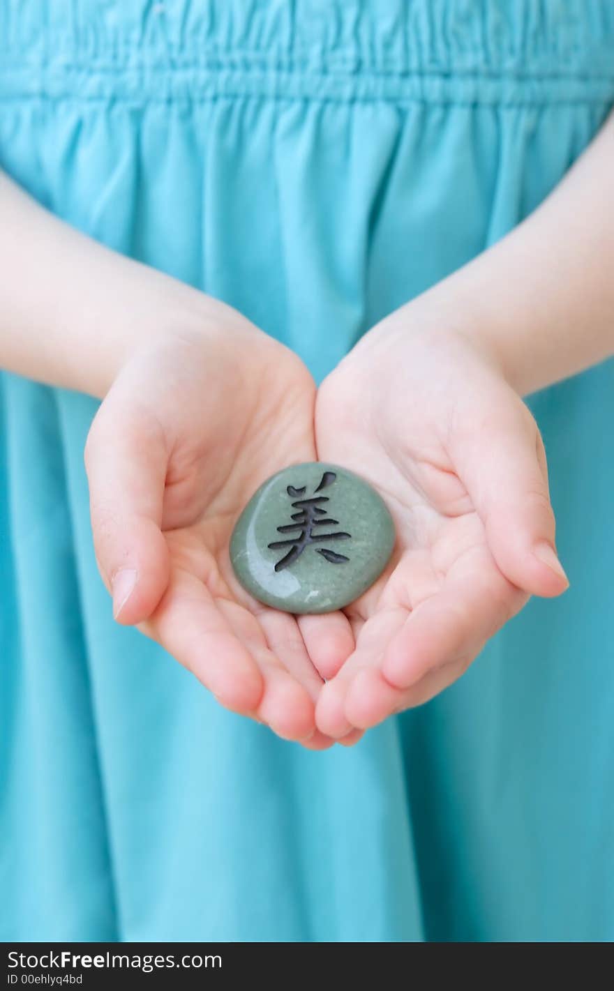 Girl is holding stone with beauty hieroglyph. Girl is holding stone with beauty hieroglyph