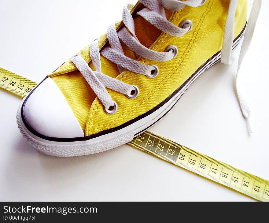 Yellow nice shoes on a tape measure