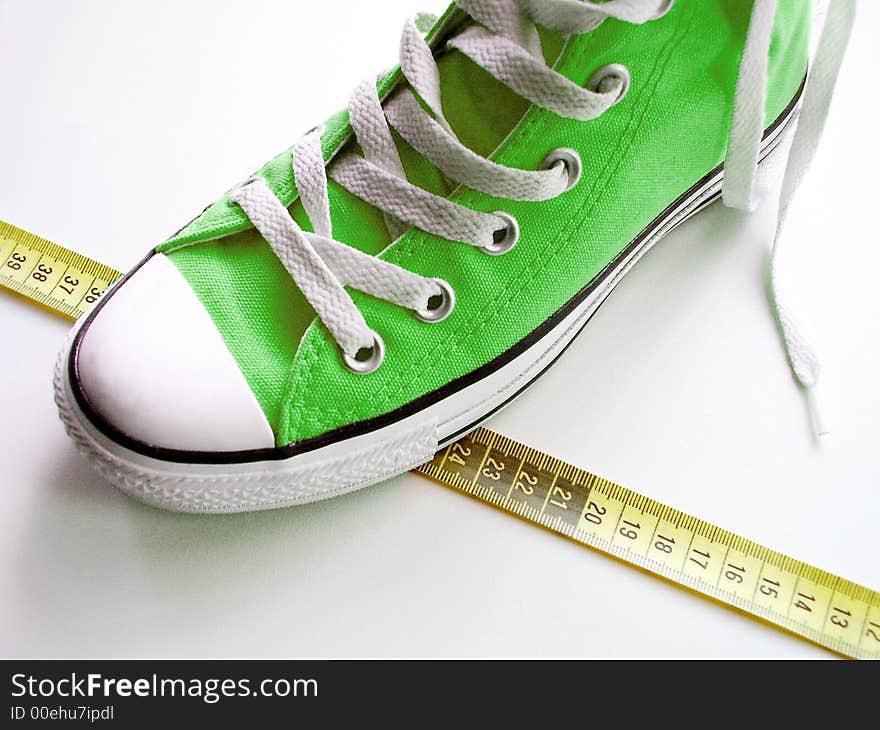 Green nice shoes on a tape measure