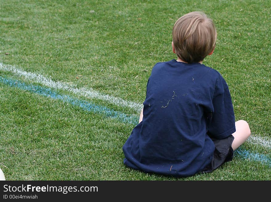 Soccer player watching game from sideline. Soccer player watching game from sideline