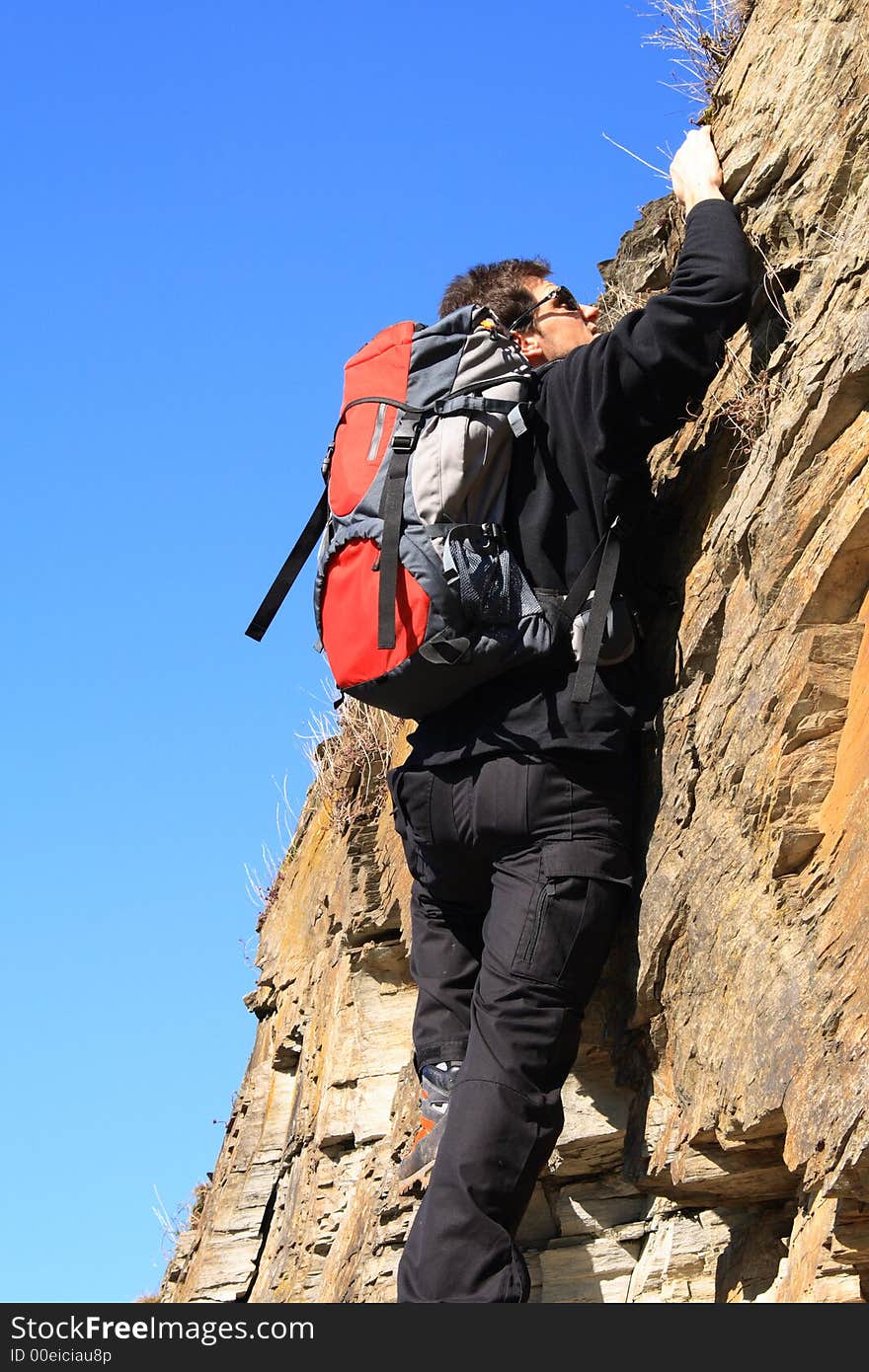 Sportsman climbing on a rock