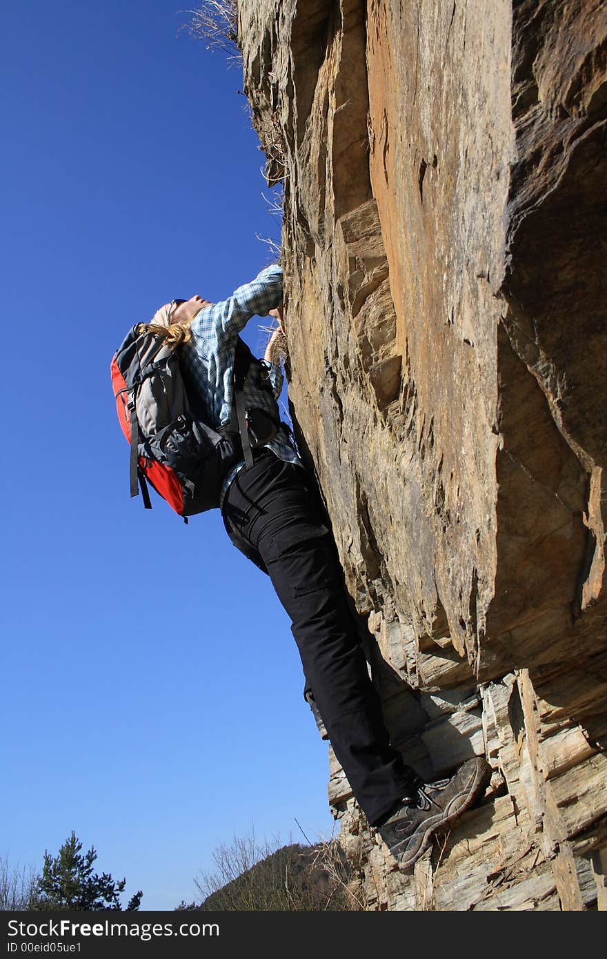 Sportsman climbing on a rock