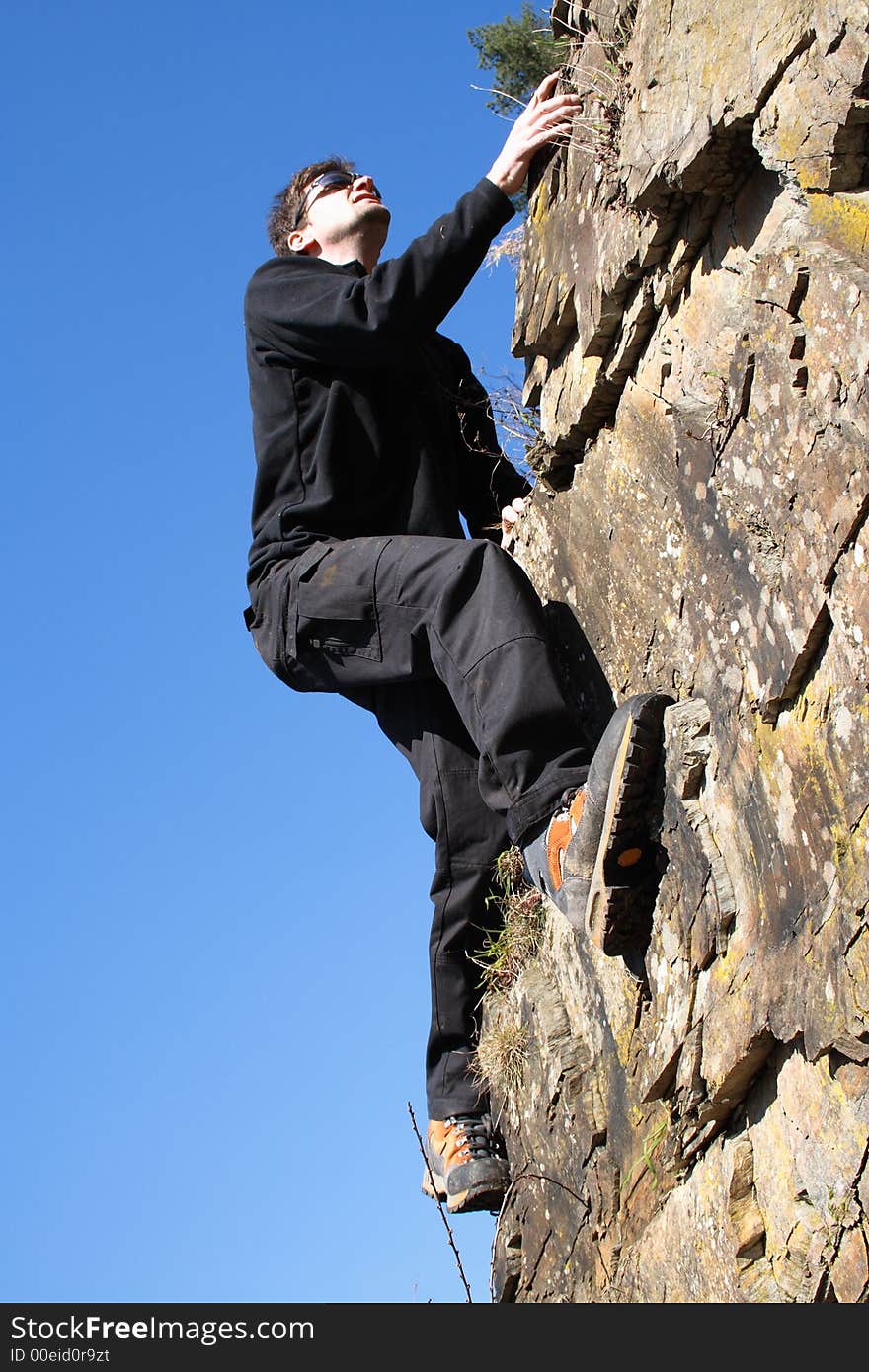 Sportsman climbing on a rock